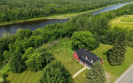 $154,900. Presque Isle Farmhouse: Riverfront Acreage, Trails & Potential