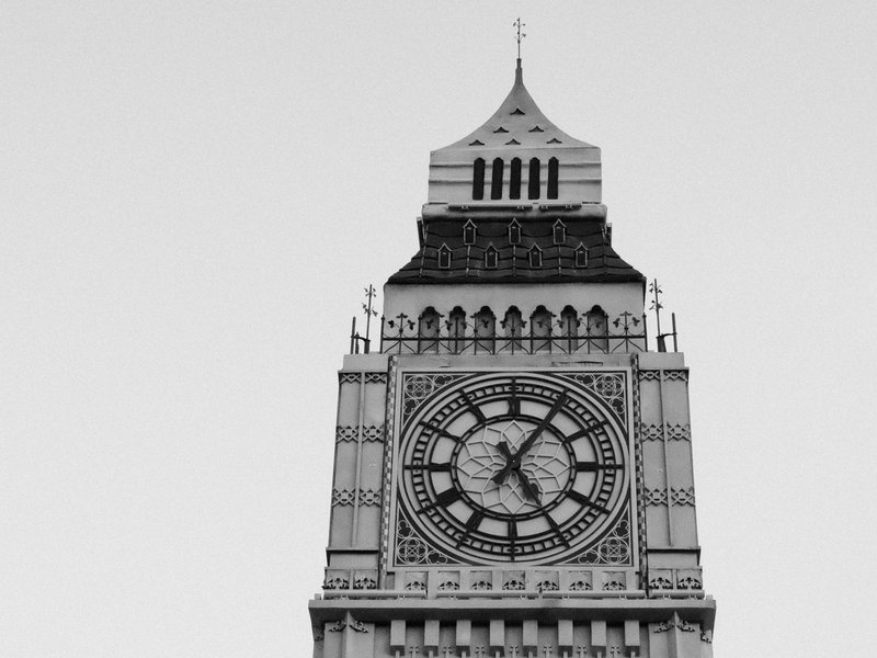 Close-up view of a clock tower with intricate architectural details and a large clock face.