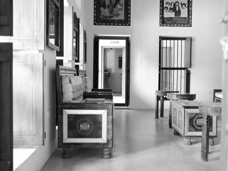 Interior view of a room with wooden furniture and framed artwork on the walls.