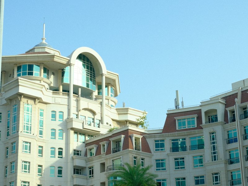 A modern architectural building with a unique design against a clear blue sky.