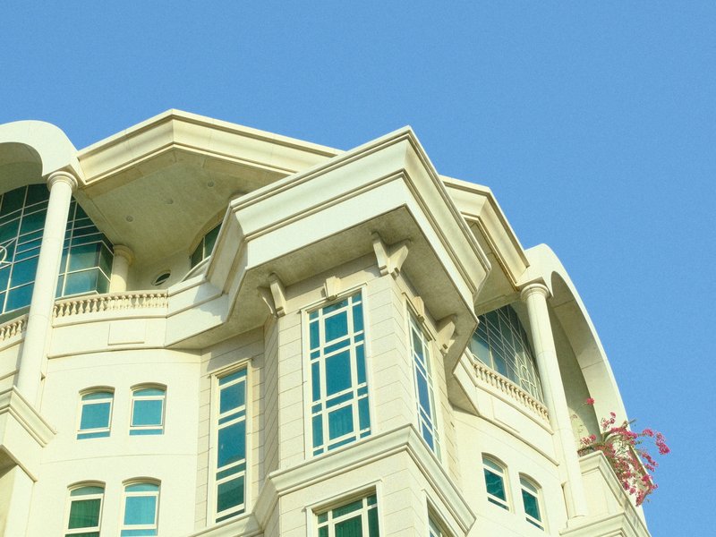 Close-up of a modern building's architectural details against a clear blue sky.
