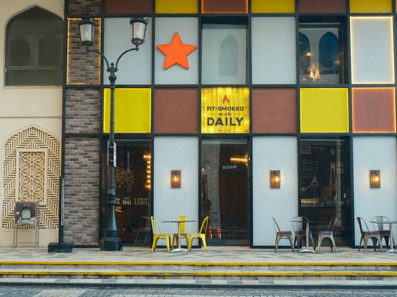 Colorful facade of a restaurant with a star sign and outdoor seating.