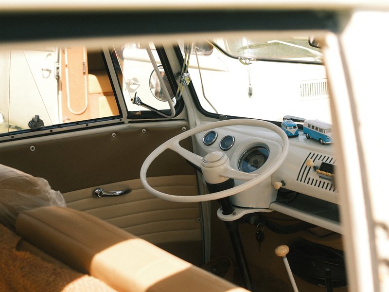 Interior view of a vintage vehicle showing the steering wheel and dashboard.