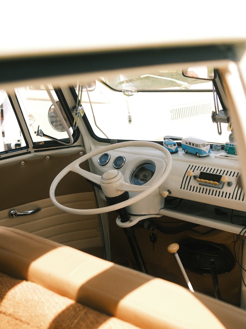 Interior view of a vintage Volkswagen van showing the dashboard and steering wheel.