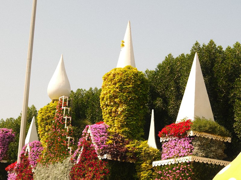 Colorful floral structures resembling fairy-tale castles with spires and vibrant flowers.