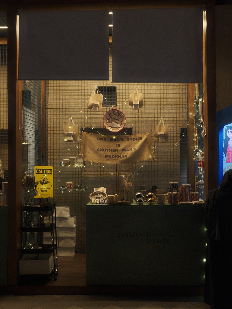A cozy shop window displaying various items with warm lighting and a welcoming atmosphere.