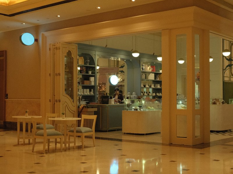 A cozy indoor café with a display of pastries and a warm ambiance.