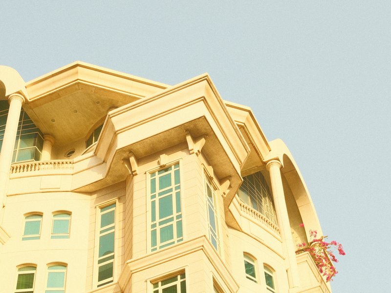 Close-up of a modern building with unique architectural features against a pale sky.