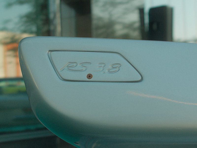 Close-up of a car's rear spoiler with a badge displaying the number 2578.