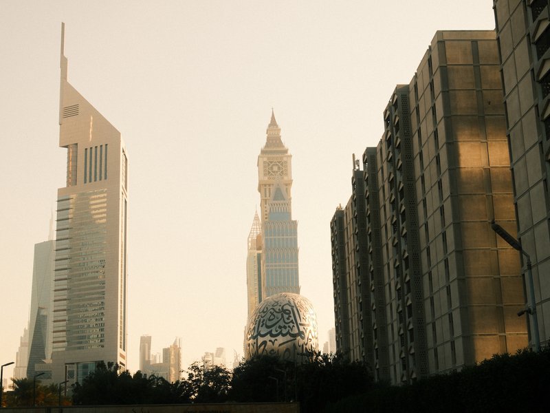 Silhouetted skyscrapers against a golden sunset sky, highlighting architectural details.