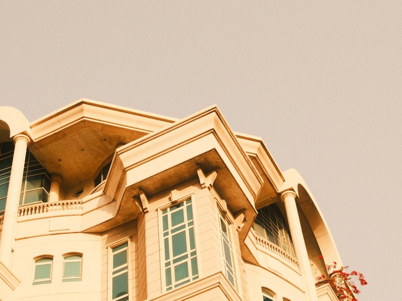 Close-up of a modern building with unique architectural features against a light sky.