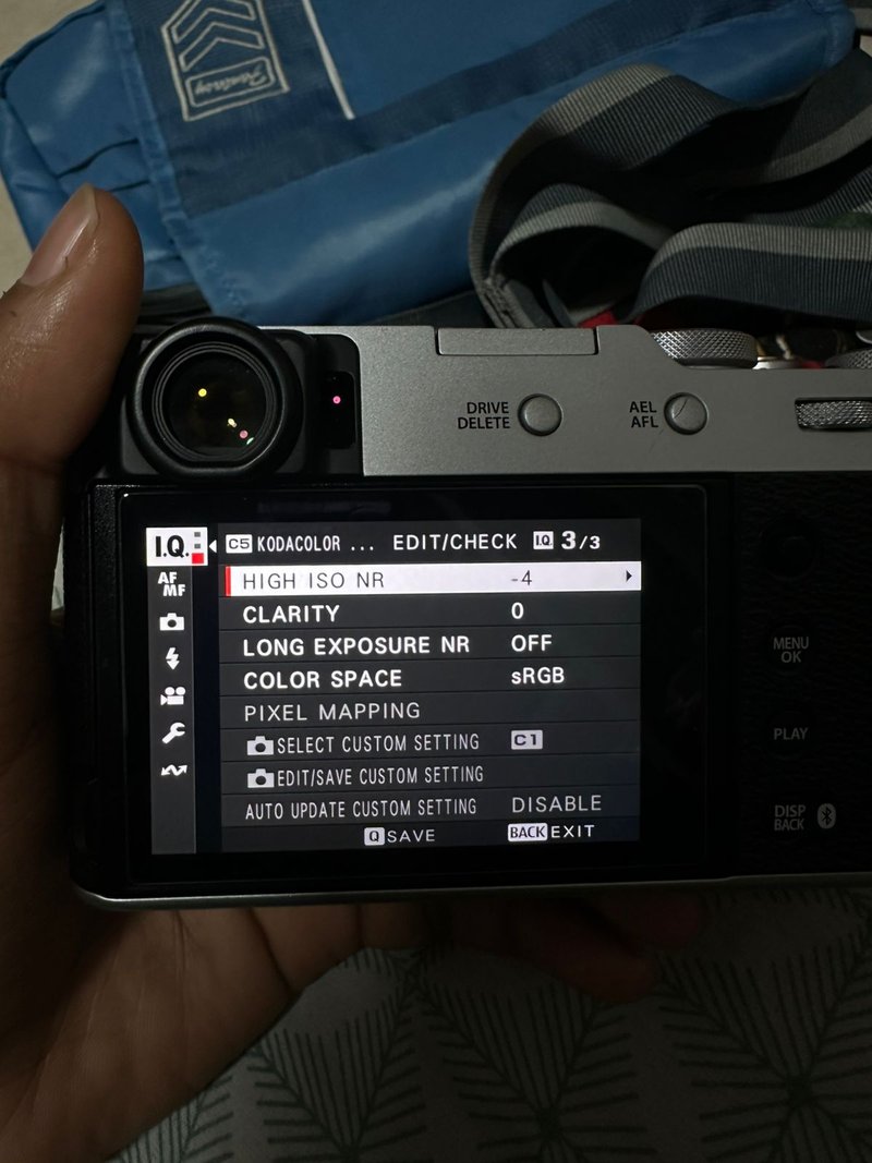 Close-up of a camera's LCD screen displaying settings and options.
