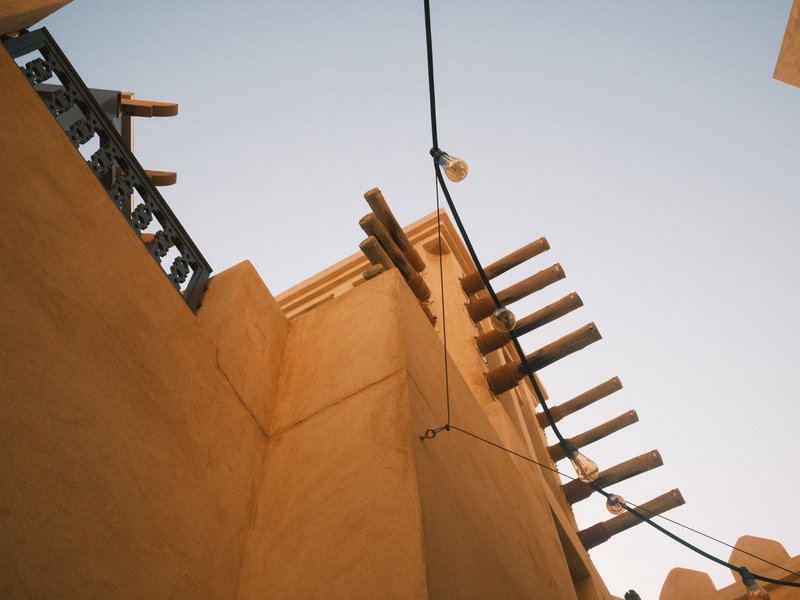 View of a traditional building with wooden beams against a clear sky.