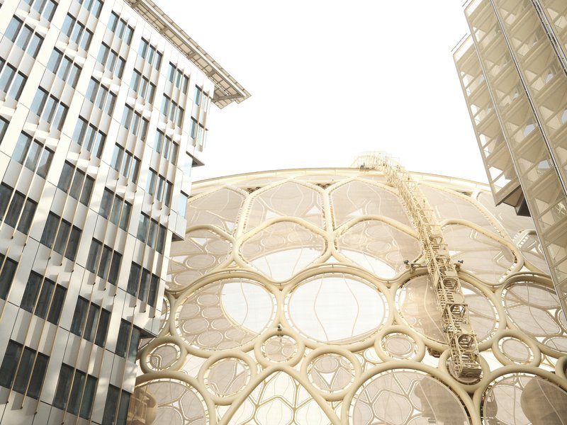 Modern architecture featuring a unique building design surrounded by glass skyscrapers.