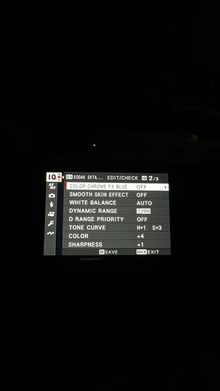 Camera settings display showing various options like white balance and sharpness.