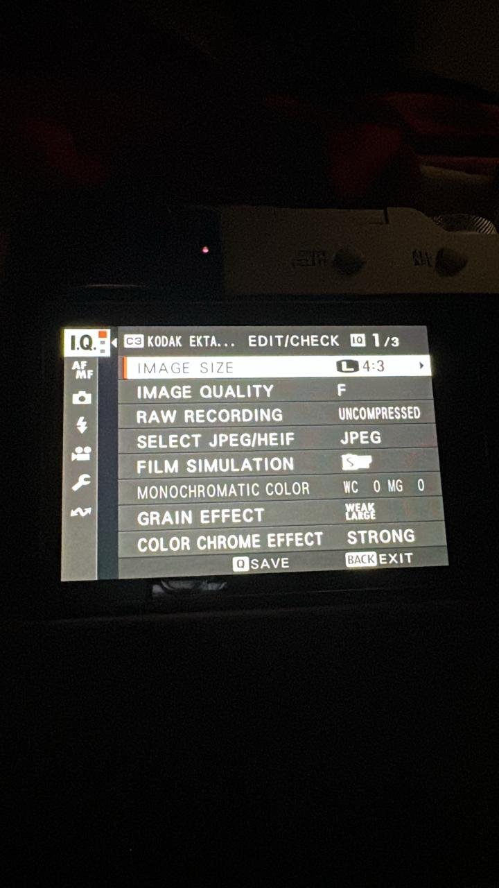 Close-up of a camera's LCD screen displaying settings and options.