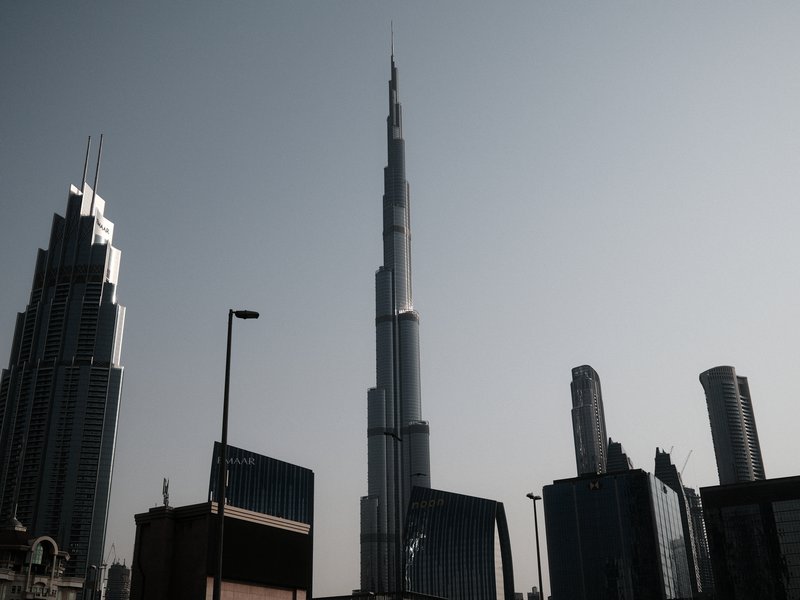 Silhouette of skyscrapers including the Burj Khalifa against a hazy sky.