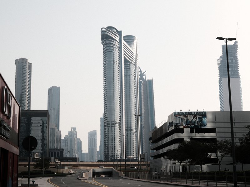 A view of modern skyscrapers in an urban setting with a clear sky.