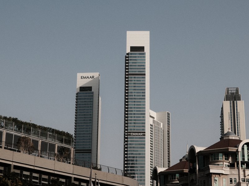 Modern skyscrapers against a clear sky, showcasing architectural design and urban landscape.