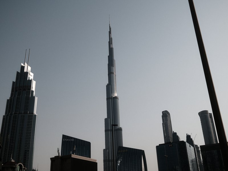 Silhouette of skyscrapers including the Burj Khalifa against a hazy sky.