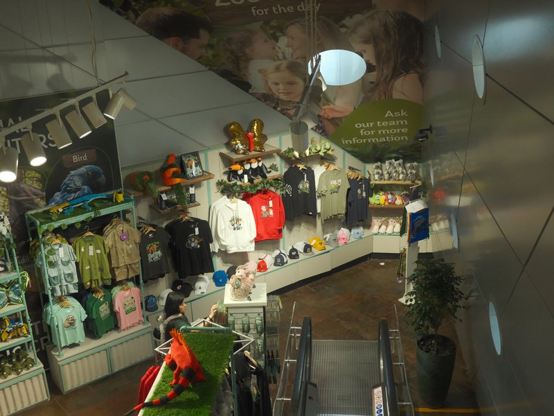 A view of a retail store interior showcasing various clothing and merchandise displays.