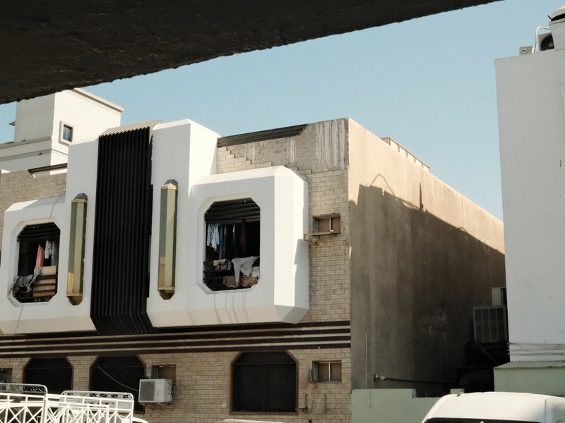 A modern building with unique architectural features, showcasing large windows and a minimalist design.