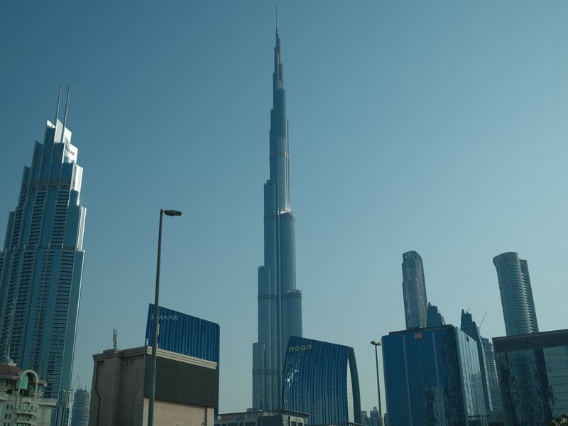Skyline featuring the Burj Khalifa and surrounding skyscrapers under a clear blue sky.
