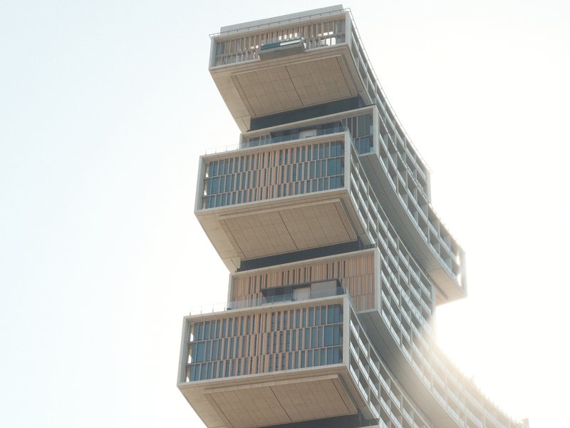 Close-up of a modern architectural building with stacked, cantilevered sections against a bright sky.