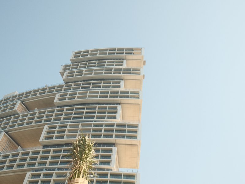 A modern architectural building with a unique design against a clear blue sky.