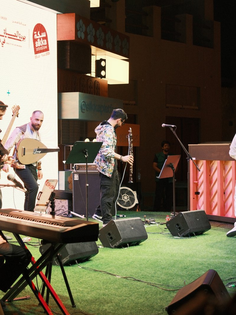 A lively music performance with musicians playing various instruments on stage.