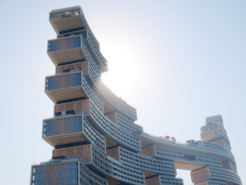 A modern architectural structure with a unique design, partially obscured by sunlight.