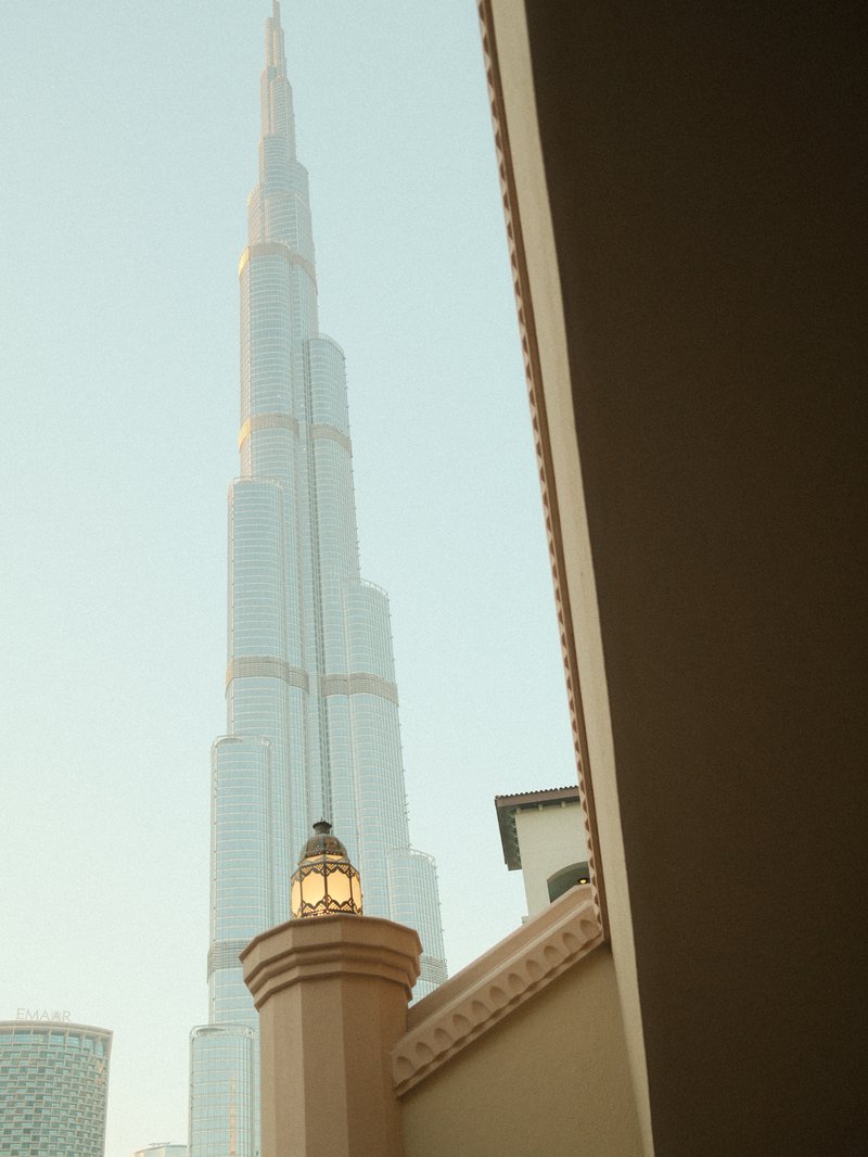 View of Burj Khalifa tower from a nearby building with architectural details in the foreground.