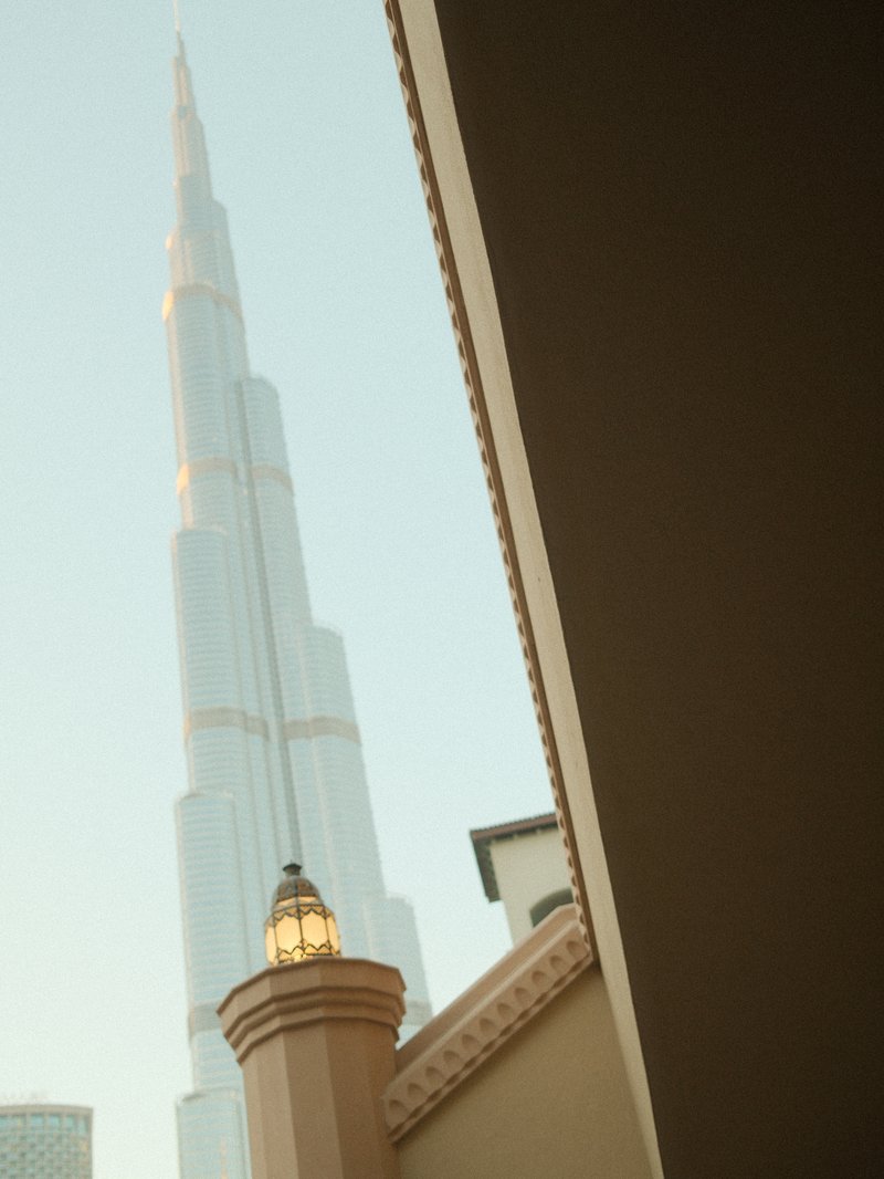 View of the Burj Khalifa tower from a corner with architectural details in the foreground.