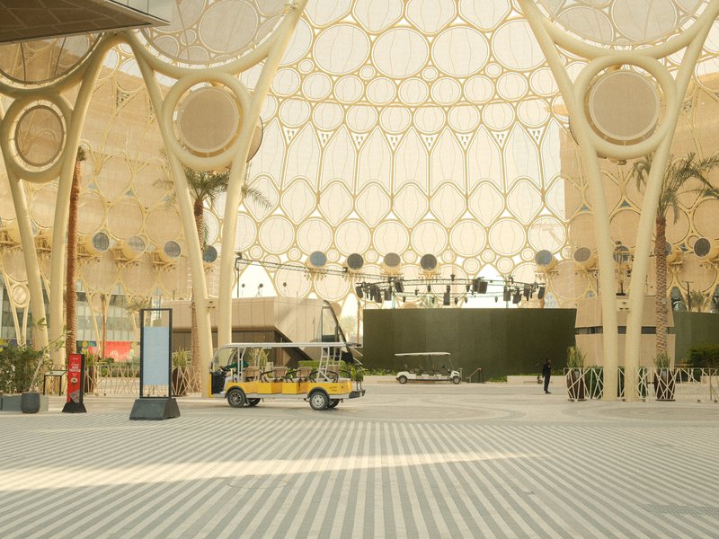 A spacious indoor area with a unique architectural design featuring circular patterns and a small vehicle.