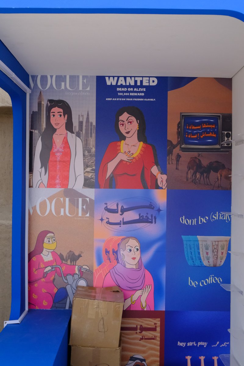 A colorful mural featuring various illustrated women and text, set against a blue background.