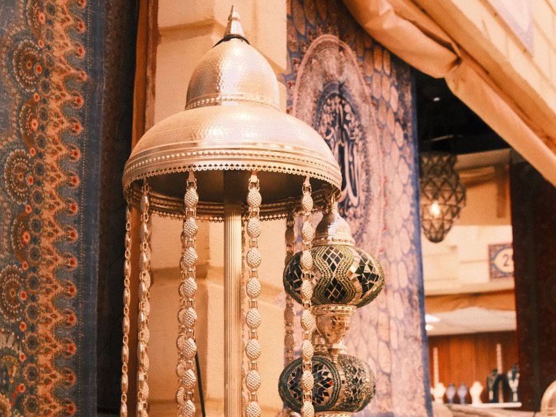 Decorative hanging lanterns with intricate designs in a warm indoor setting.