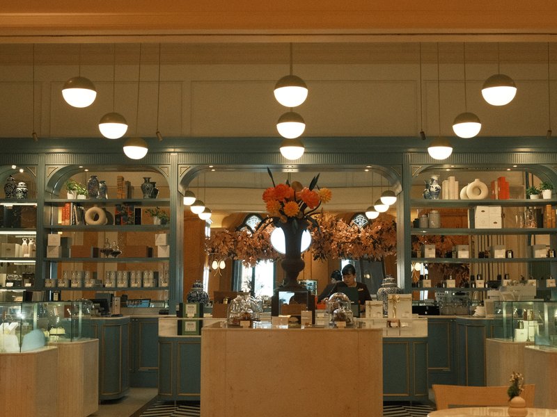 Interior of a charming shop with decorative shelves and warm lighting.