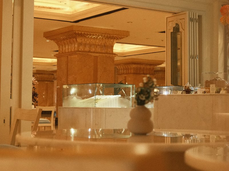 Interior of a restaurant with elegant decor, featuring a glass display and soft lighting.