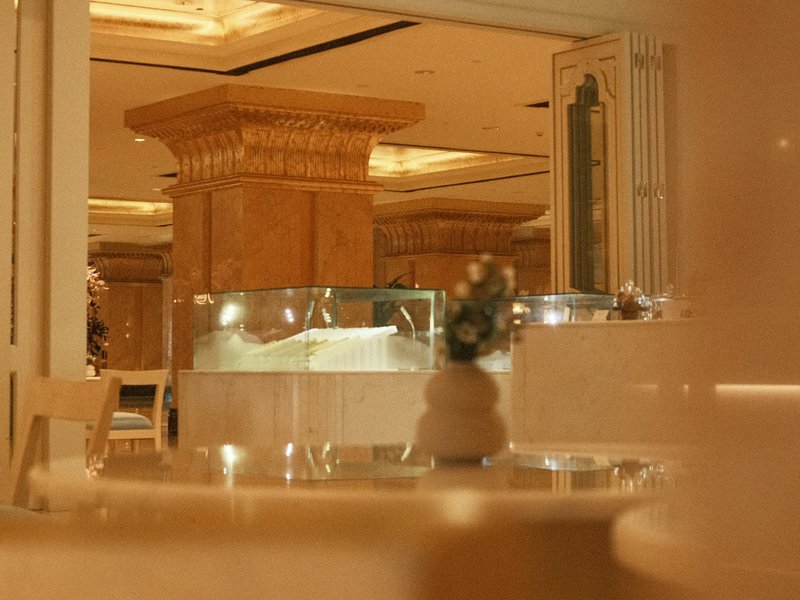 Elegant indoor setting with marble surfaces and soft lighting, featuring decorative elements.