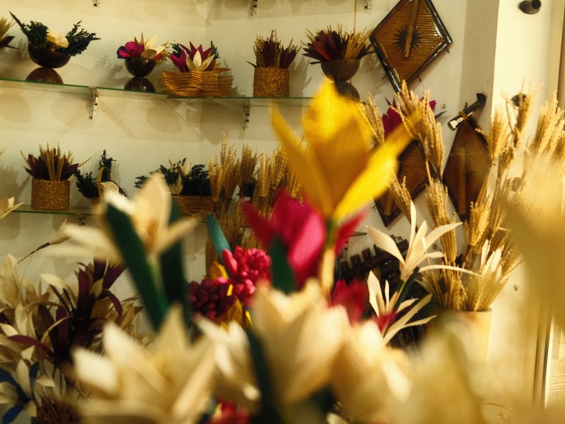 Colorful dried flower arrangements displayed in a shop with a warm atmosphere.