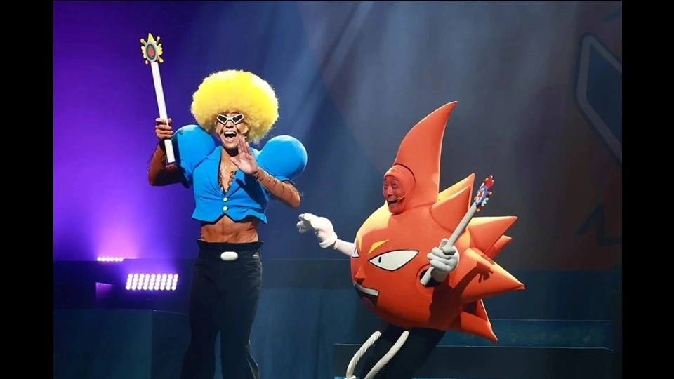 Stage show of bobobo bo bo bo o where two very zany characters hold wands up