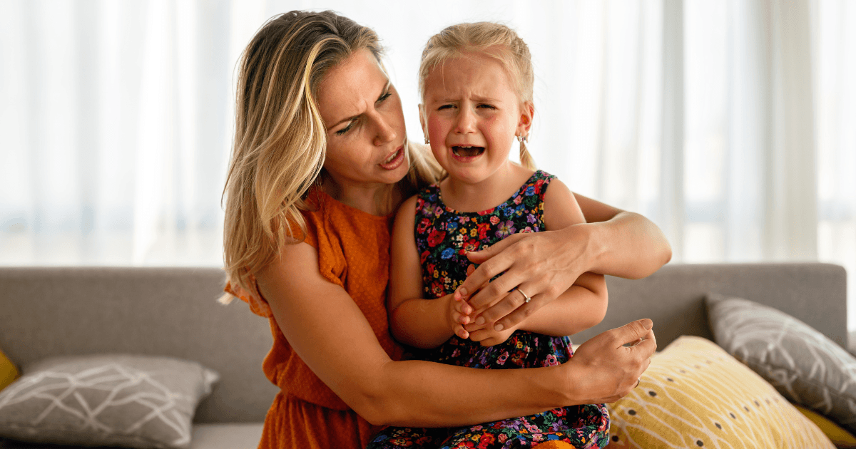 Mother comforting a crying child.