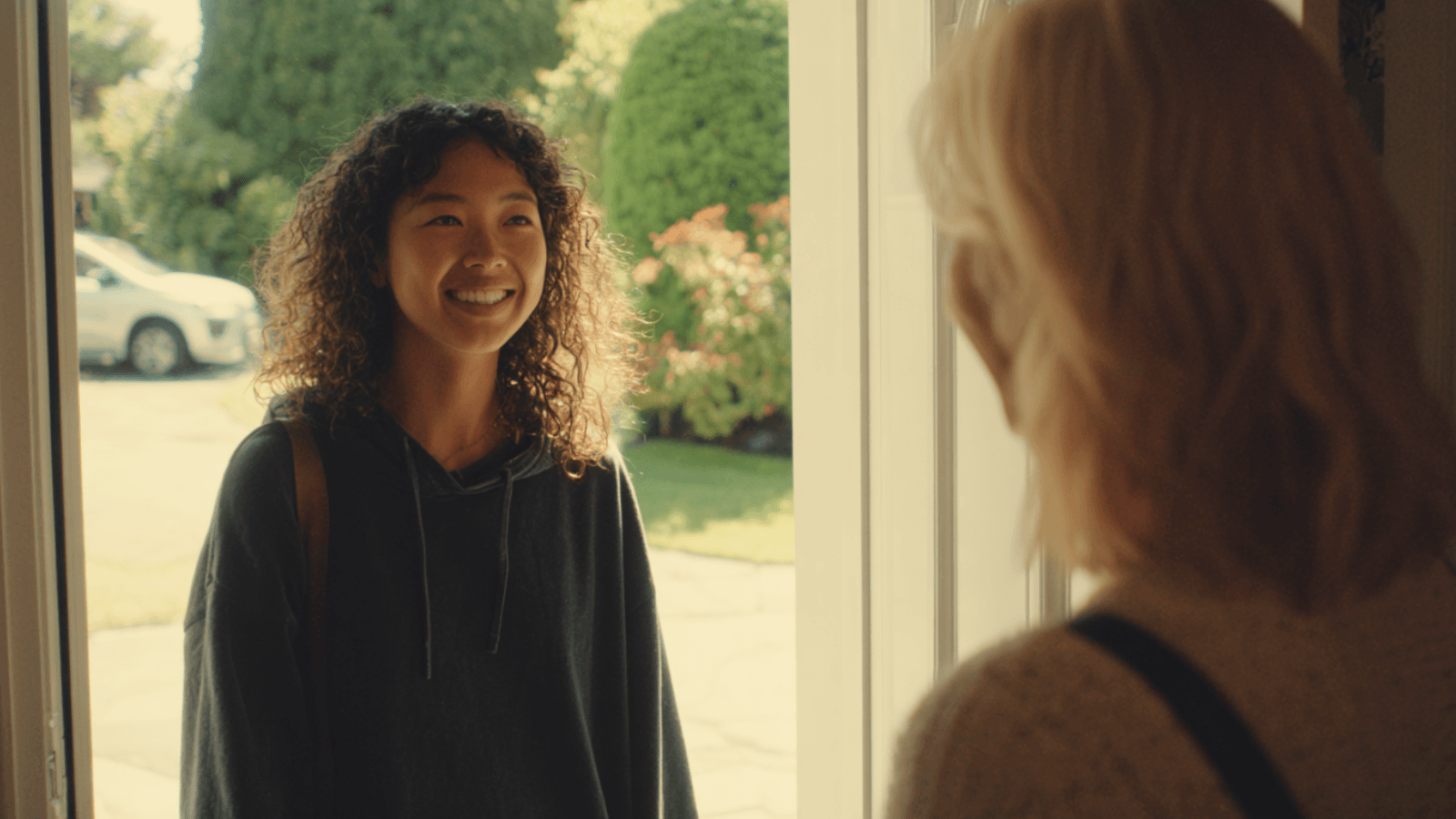 Nanny greeting the mother at the door.