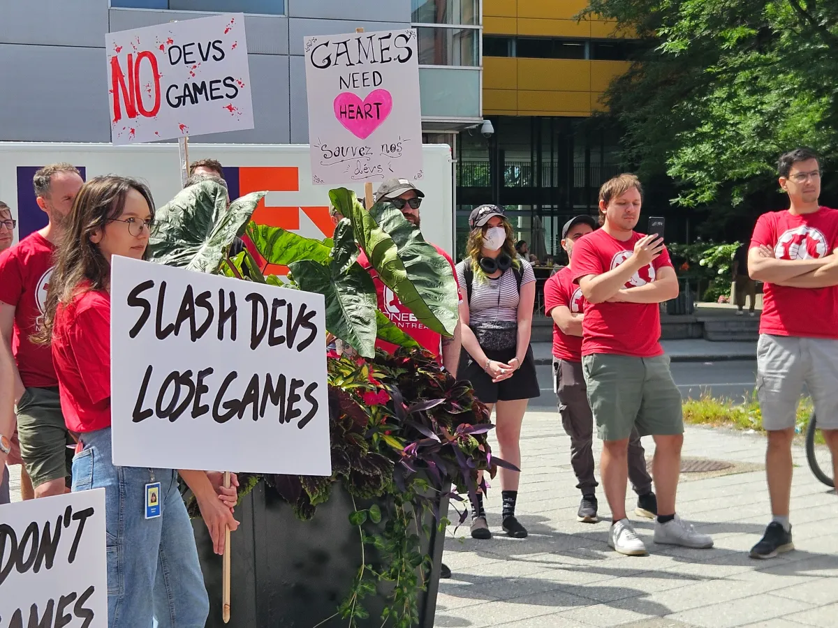 CWA Save Our Devs rally crowd with anti-Microsoft layoff signs