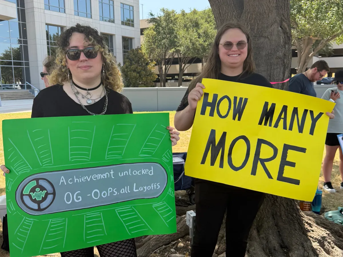Game workers holding Xbox-branded signs at Save Our Devs rally