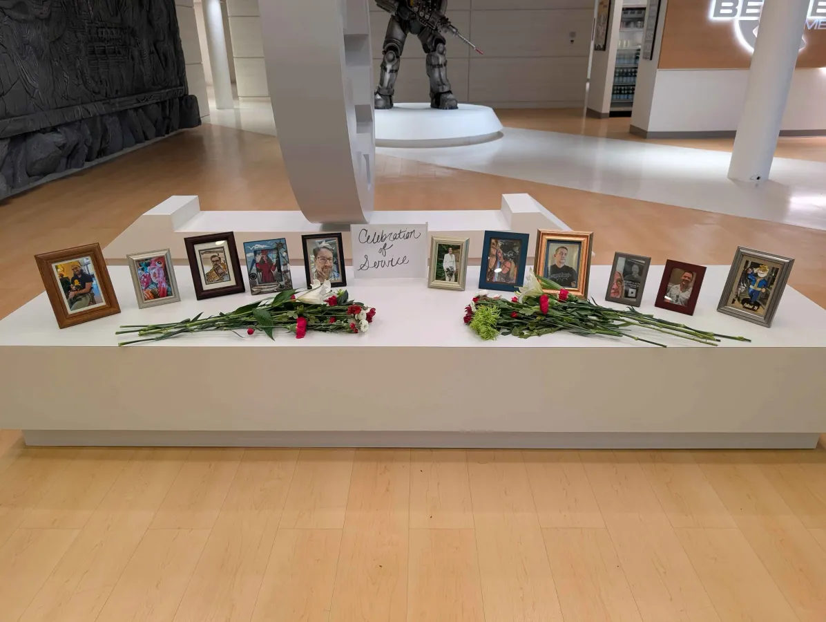 Photos of laid-off Bethesda Game Studios employees displayed at the Rockville Maryland office memorial posted by the BGS Union