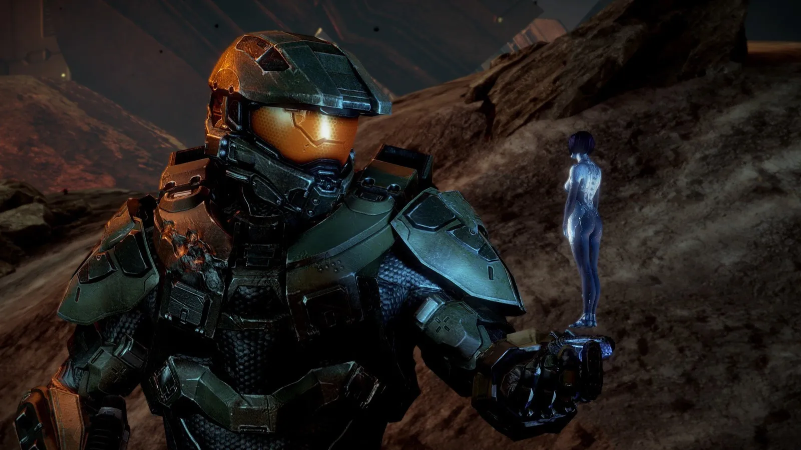 Master Chief holding Cortana hologram in Halo 4 scene with battle damaged armor