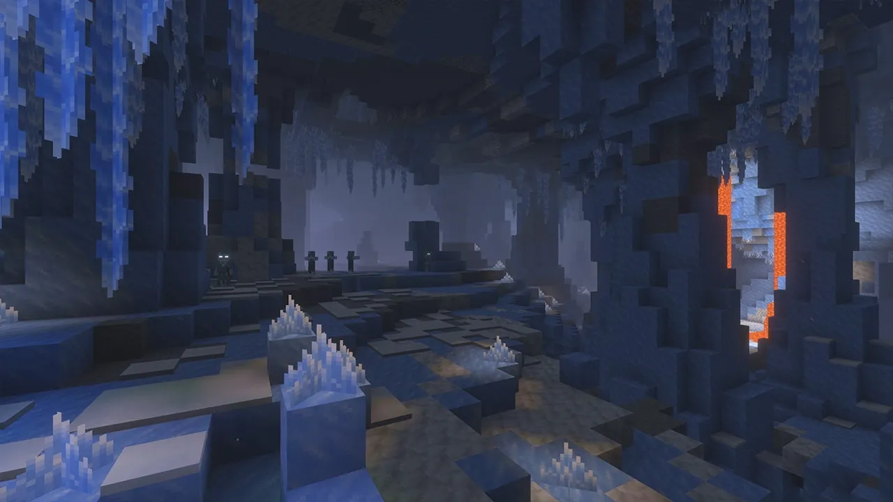 Dark Minecraft ice cave with hanging icicles and frozen terrain from the upcoming winter game drop
