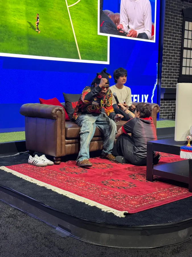 Two players compete on stage during the Netflix and FIFA Couch Cup at Fanatics Fest