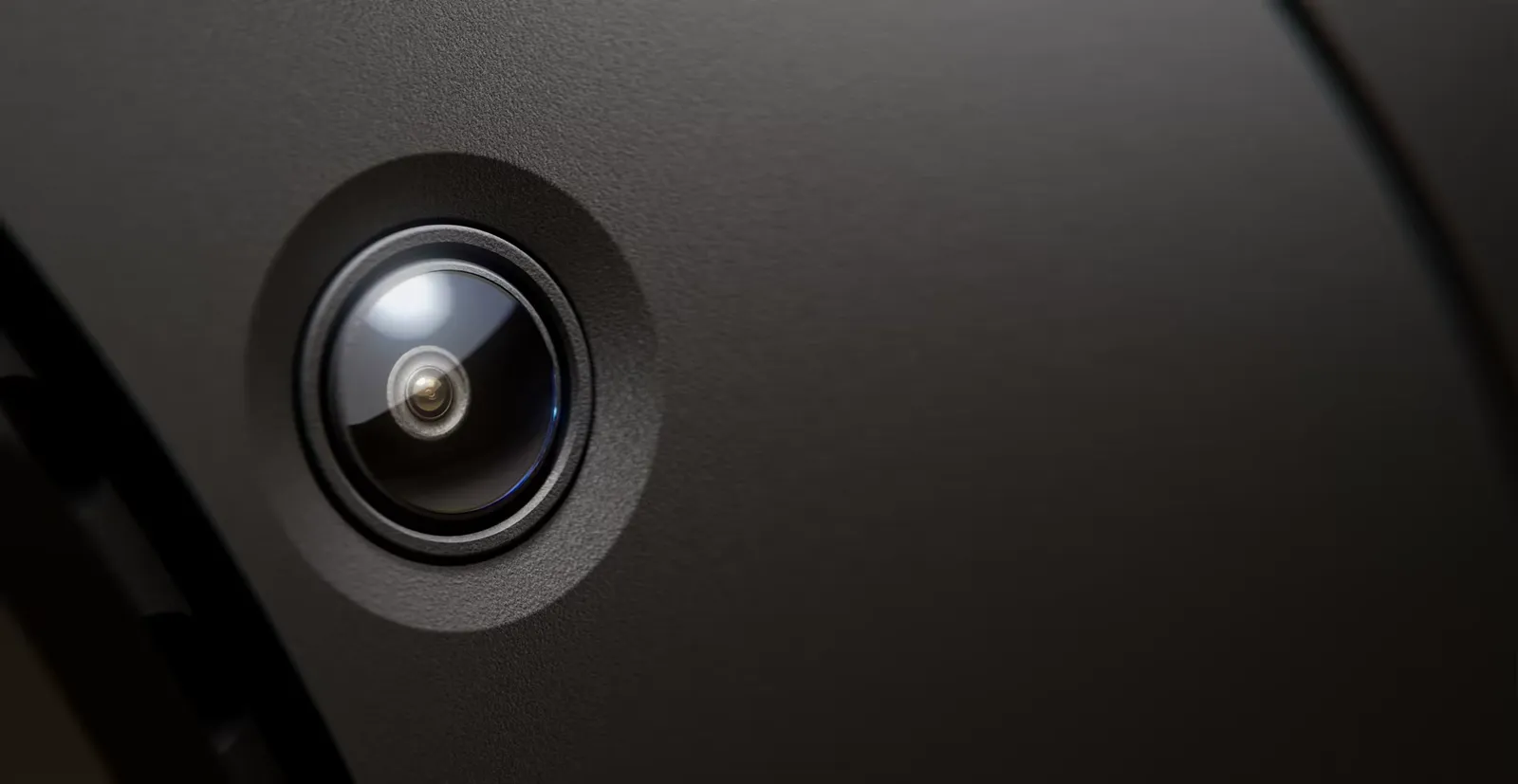 Close-up of a tracking camera set into the dark housing of the Steam Frame headset